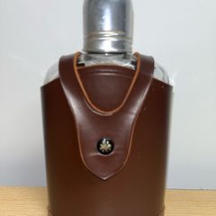Vintage whiskey flask in brown leather case