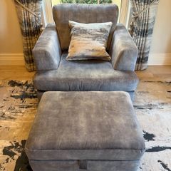 Grey fabric armchair with matching footstool