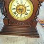 Lovely Ansonia New York Victorian Bracket clock ca 1880s. Original Enamel Dial and fine ornate black hands. 8 day gong striking Ansonia movement. Carved stepped base ornate case with gold tone brass bezel and pillars either side of the front. Good conditi Image 4