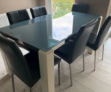 Glass topped dining table and six chairs