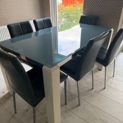 Glass topped dining table and six chairs