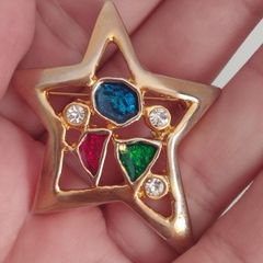 A gold star-shaped brooch.