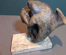 Free form bog oak statue on red marble
