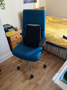 Blue office chair with support pillow.