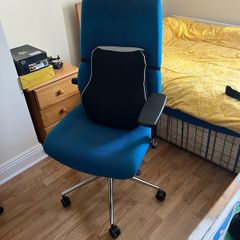 Blue office chair with support pillow.
