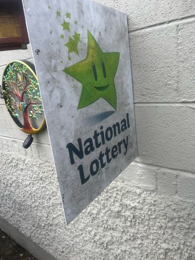 Double sided national lottery wall sign.
