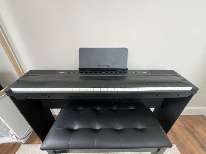 piano, bench and audio transmitter