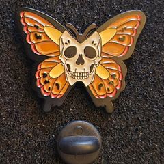 Skull/butterfly , pin back badge.