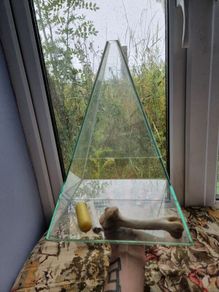 Glass ritual pyramid with bones and candle