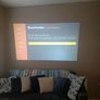 philips neopix ultra 2tv+ home projector and height adjustable stand, built in speakers and android TV with play store stand comes with power point bracket on it as seen in pictures also remote and phone holder Image 7