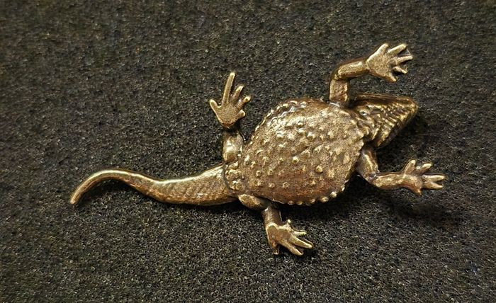 3 brass lizards.