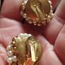 Vintage clip-on earrings with a cluster of faux pearls and gold-tone beads. Image 5