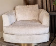 Cream chenille swivel cuddler / armchair