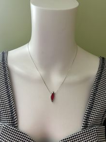 Delicate silver tone chain necklace with red pendant