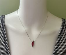 Delicate silver tone chain necklace with red pendant