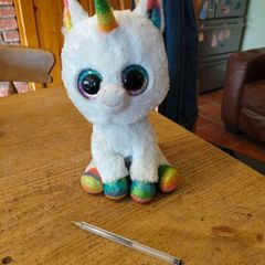 This is a Ty Beanie Boos Pixy the White Unicorn plush toy with large, glittery eyes