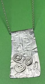 Handmade sterling silver long pendant with Celtic Triskele. 18 inch necklace