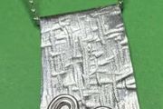 Handmade sterling silver long pendant with Celtic Triskele. 18 inch necklace