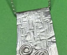 Handmade sterling silver long pendant with Celtic Triskele. 18 inch necklace