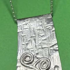 Handmade sterling silver long pendant with Celtic Triskele. 18 inch necklace