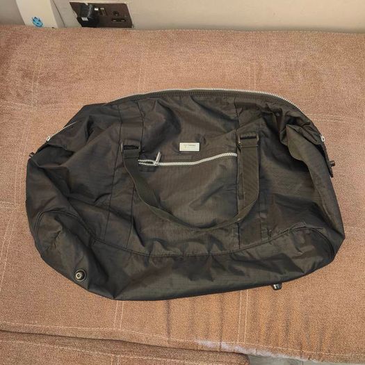 Large black expandable travel bag with shoulder strap