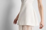 Strapless mini overlay maxi dress features a tailored bandeau top with a contrasting sheer floral lace skirt