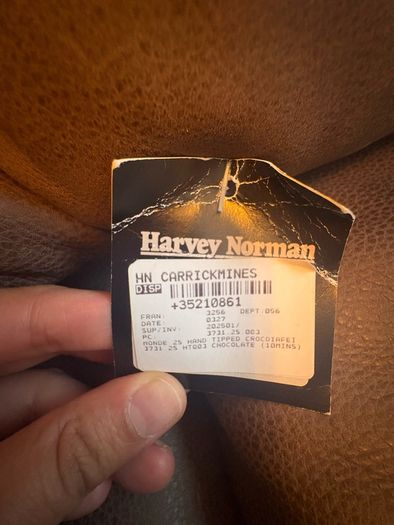 Leather sofa with original harvey Norman tag still attached