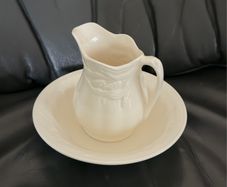 An antique Weatherby Design ironstone pitcher and bowl set featuring a wheat pattern.