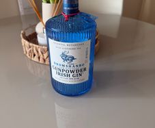 Blue gunpowder gin bottle with cork string lights
