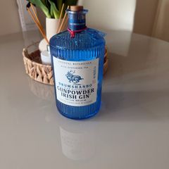 Blue gunpowder gin bottle with cork string lights