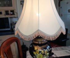 Beautiful Old Large Creamic Table Lamp  Hand Painted Floral Motifs Decorative Chinoiserie Inspired, and a Cream Colored Fabric Shade with Fringed Edging.