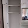 Double bedroom wardrobe with drawers and mirror in-between wardrobes and plenty of storage above Image 4