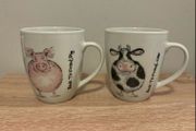 A Pair of Porcelain Cow and Pig Mugs
