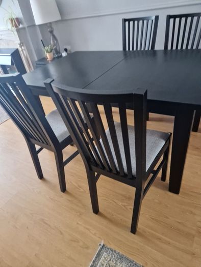 Black dining table with four chairs