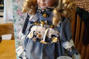 Leonardo Collectors porcelain doll, new in box.