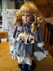 Leonardo Collectors porcelain doll, new in box.