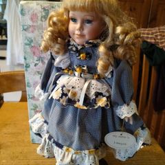 Leonardo Collectors porcelain doll, new in box.
