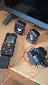 Sony Ericsson W200i , with charger and speakers.