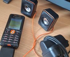 Sony Ericsson W200i , with charger and speakers.