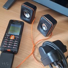 Sony Ericsson W200i , with charger and speakers.