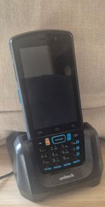 The item is a Unitech EA320 handheld barcode scanner