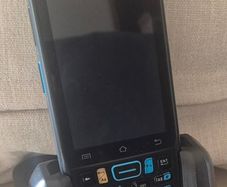The item is a Unitech EA320 handheld barcode scanner