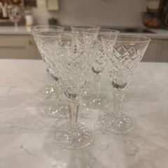 Waterford crystal sherry glasses with a classic cut-crystal design and elegant faceted stems.