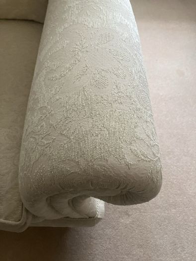 Cream armchair on brass caster