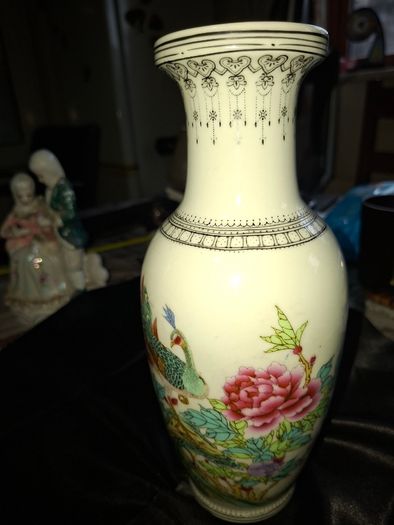 Chinese porcelain vase from the Jingdezhen region featuring a hand painted peacock and floral motif., Postage Available