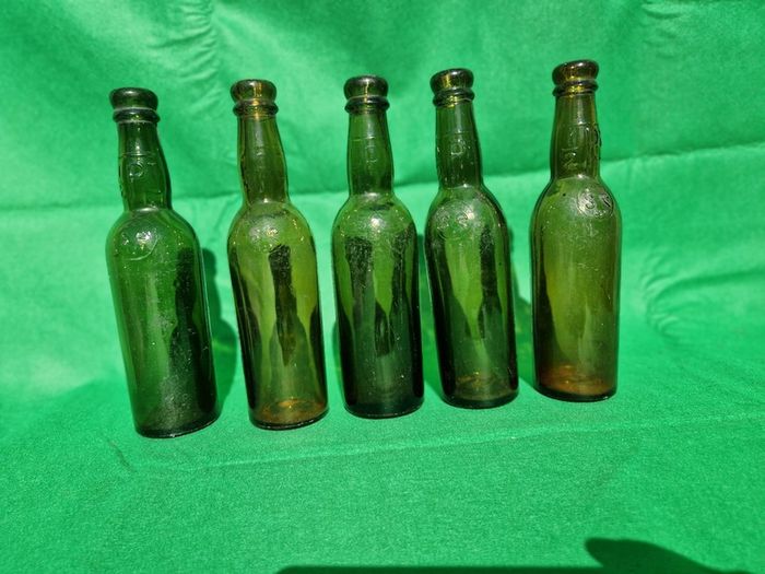24 Antique 1/2 pint bottles in crate