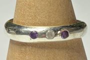 Handmade sterling silver ring with flush set stones. Size O