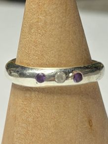 Handmade sterling silver ring with flush set stones. Size O