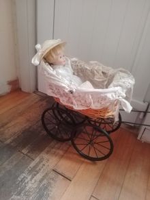 vintage toy pram and doll