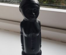 Vintage miniature "VUDU" bottle made of opaque black glass.
